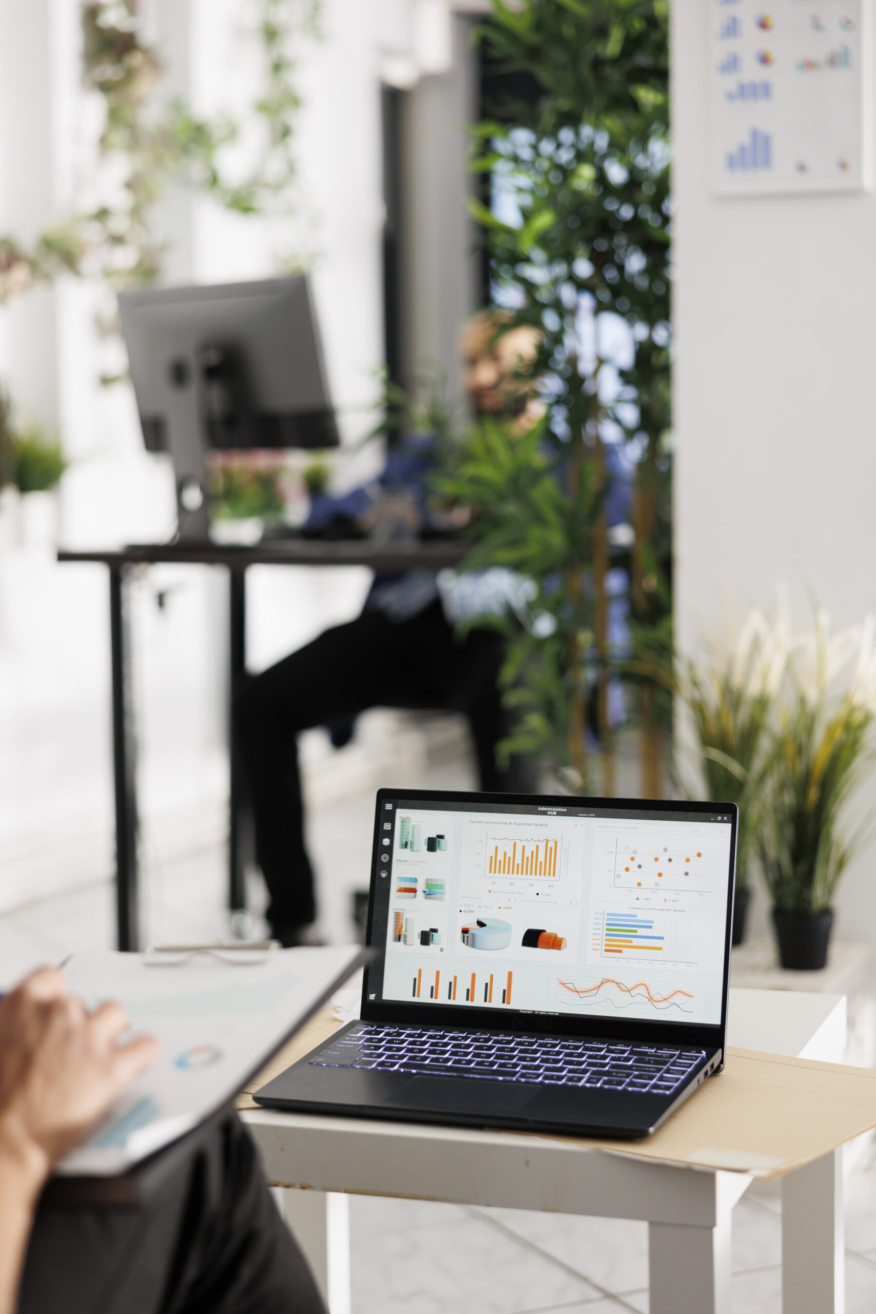 Employee reviewing sales data on laptop screen and budgeting strategy in business office. Worker analyzing metrics statistics charts on portable computer in coworking space ntrust accountants australia